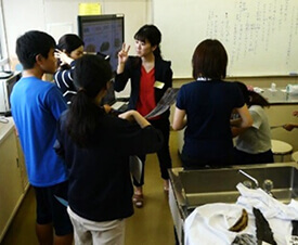 うま味という味覚を伝えるために用意した創作手話を使いながら、出前授業を進行する様子。